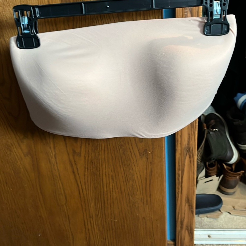 Nude color Victoria Secrets strapless or strap bra.
